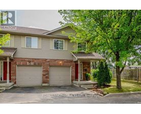 A house with a red door and a garage.