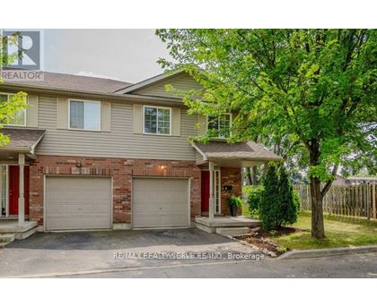 A house with a red door and a garage.