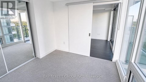 A room with a sliding door and a carpeted floor.