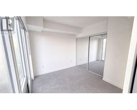 A room with a sliding glass door and a carpeted floor.