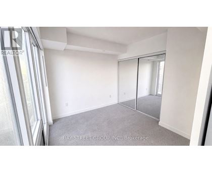 A room with a sliding glass door and a carpeted floor.