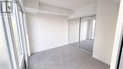 A room with a sliding glass door and a carpeted floor.