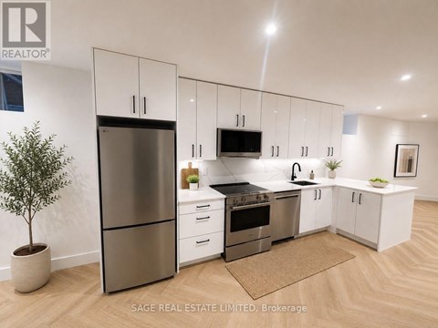 A modern kitchen with white cabinets and stainless steel appliances.
