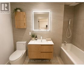 A bathroom with a toilet, sink, mirror, and bathtub.