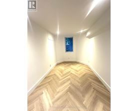 A room with a chevron patterned floor and a window.