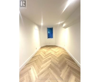 A room with a chevron patterned floor and a window.