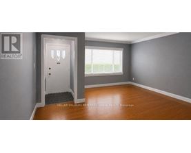 A room with a door and a window with blinds.