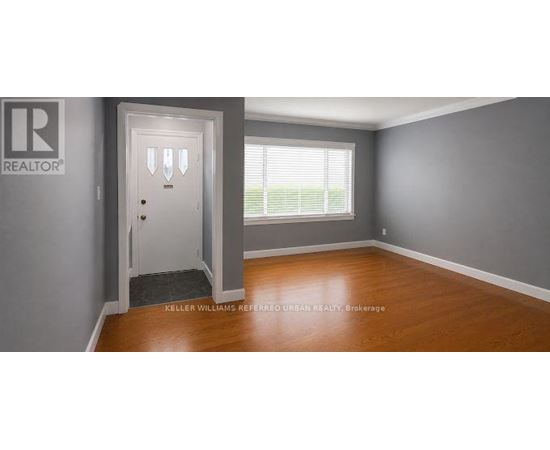 A room with a door and a window with blinds.