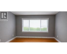 A room with a window and a sign on the wall.