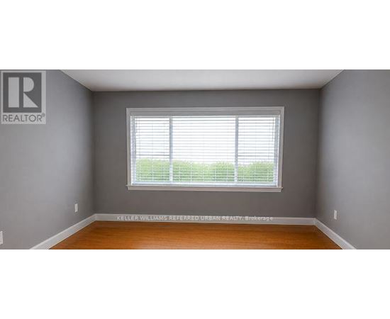 A room with a window and a sign on the wall.