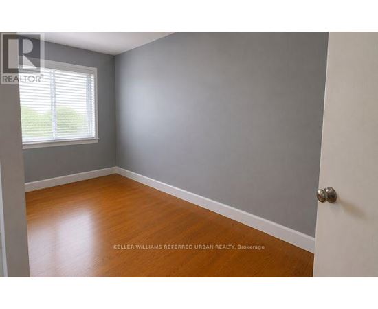 A room with a wooden floor and a white door.