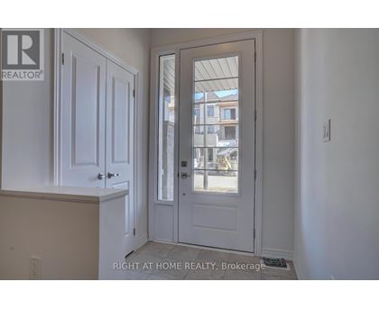 A white door with a glass window is in a room with white walls.