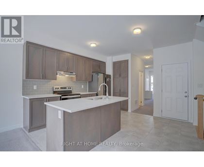 A kitchen with a white counter top and brown cabinets.