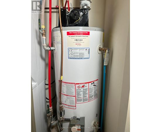 A tankless water heater is installed in a narrow space.