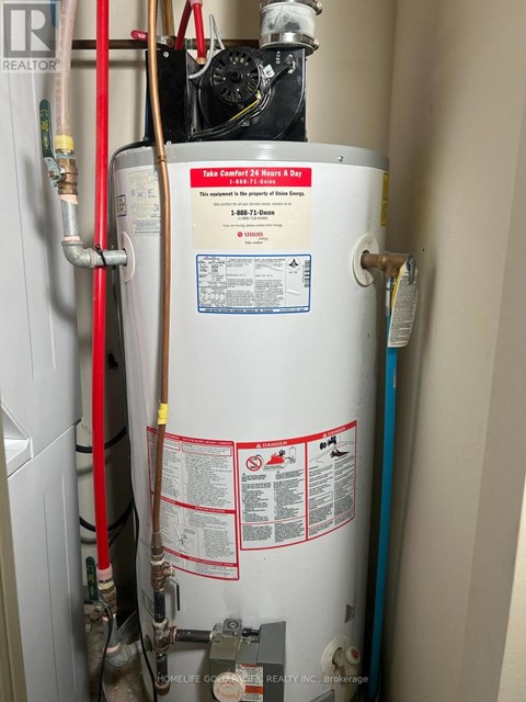 A tankless water heater is installed in a narrow space.