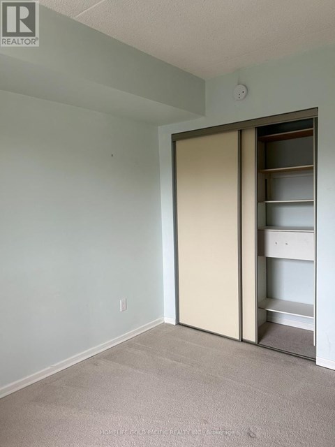 A room with a sliding door and a shelf.