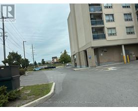 A parking lot in front of a building with a sign that says "HOMELIFE GOLD PACIFIC REALTY INC., Brokerage".