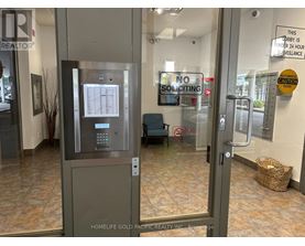 A sign on the door of a building states that it is under 24 hour surveillance.