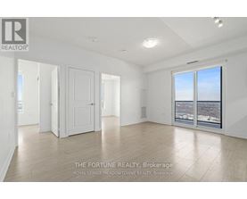 A large, empty room with a view of the city through a large window.