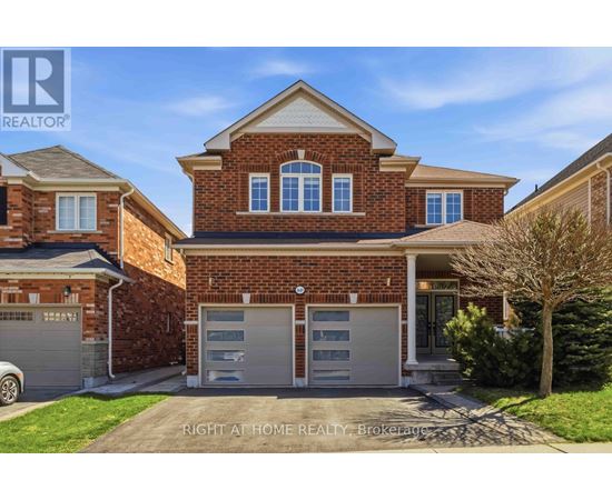 A brick house with a garage is for sale.