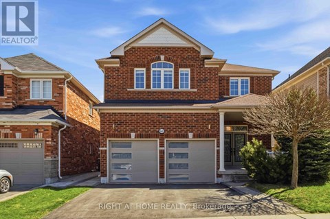 A brick house with a garage is for sale.