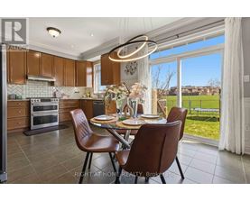 A well-lit kitchen with brown chairs and a table set for two.