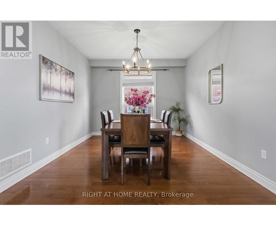 A dining room with a wooden table and chairs.
