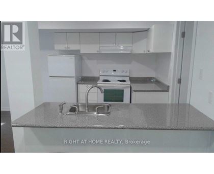 A kitchen with a stove top oven and a sink.
