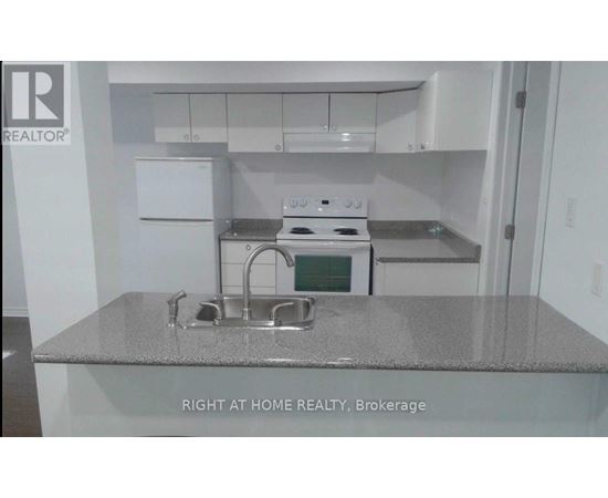 A kitchen with a stove top oven and a sink.