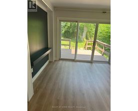 A room with a sliding glass door leading to a deck.
