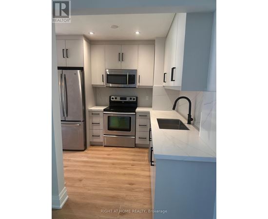 A kitchen with a stove top oven and microwave above it.