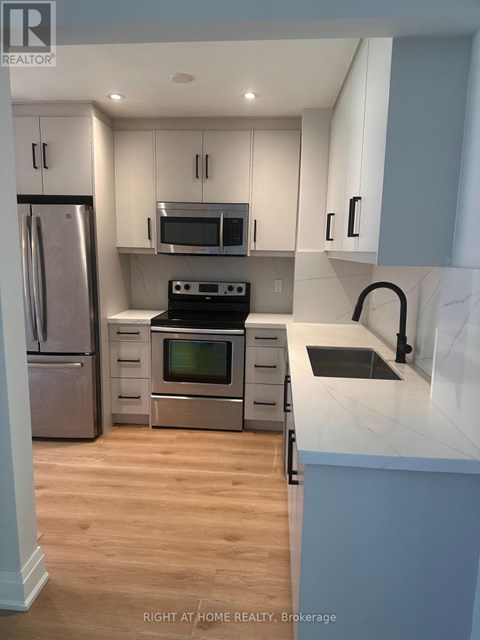 A kitchen with a stove top oven and microwave above it.