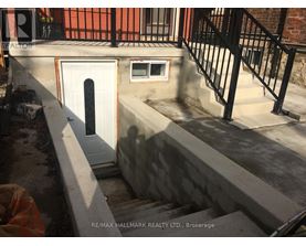 A concrete staircase with a white door and a window is being constructed.
