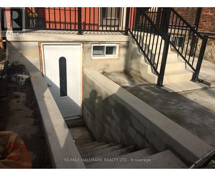 A concrete staircase with a white door and a window is being constructed.