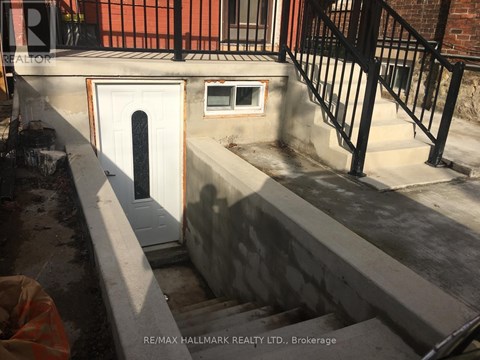 A concrete staircase with a white door and a window is being constructed.