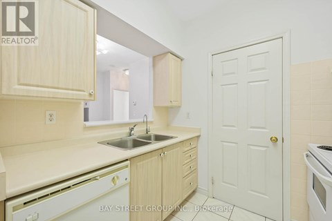 A kitchen with wooden cabinets and a white door.