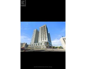 A tall building with many windows is the main focus of the image.