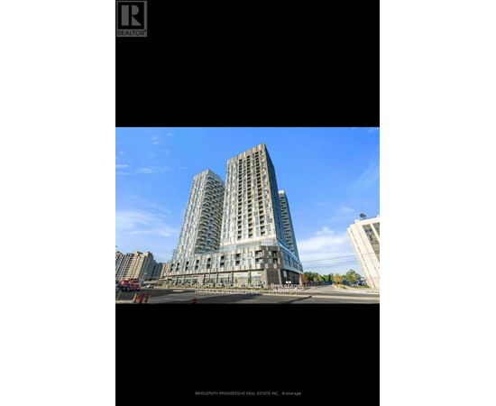 A tall building with many windows is the main focus of the image.