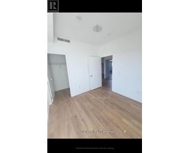 A room with wooden flooring and white walls.