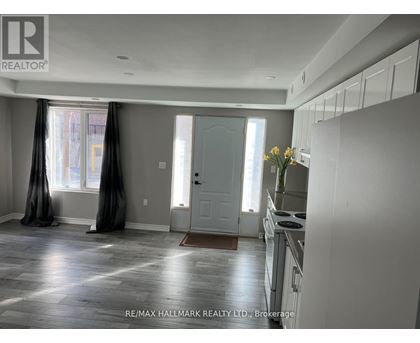 A kitchen with white cabinets and a stove top oven.