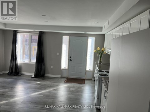 A kitchen with white cabinets and a stove top oven.