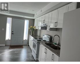 A kitchen with white cabinets and a sink.