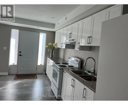 A kitchen with white cabinets and a sink.