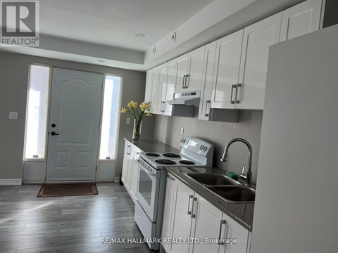 A kitchen with white cabinets and a sink.