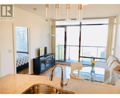 A kitchen with a sink and a window overlooking the city.
