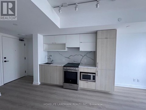 A kitchen with a stove top oven and microwave built into a cabinet.