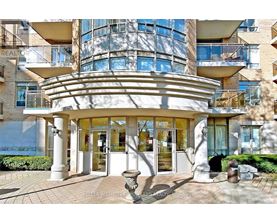 A modern building with a curved entrance and a glass facade.