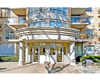 A modern building with a curved entrance and a glass facade.