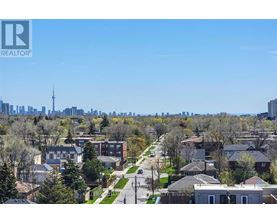 A residential area with houses and a city skyline in the background.