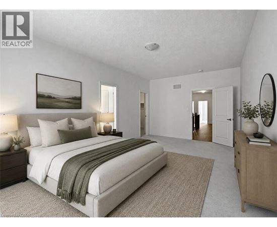 A bedroom with a large bed, a nightstand with a lamp, a dresser, and a mirror.